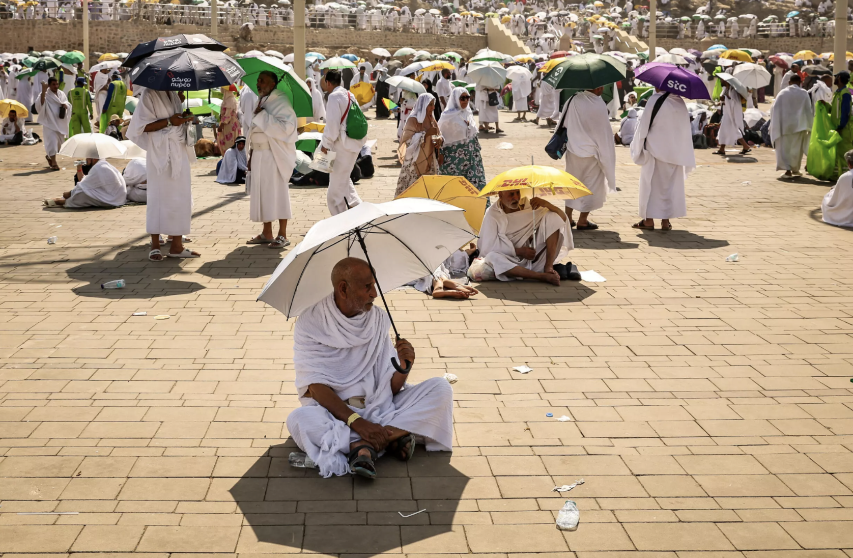 Muslim pilgrims use umbrellas to shade themselves from the sun as they arrive at the base of Mount Arafat during the hajj © Fadel SENNA / AFP